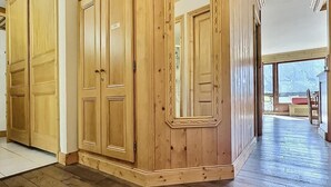 A hallway with wooden paneling and a large mirror.