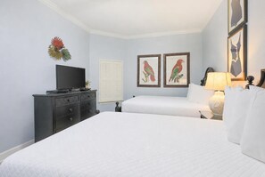 A hotel room with two beds, a TV on a dresser, and framed artwork on the walls. - The Oasis at Orange Beach, formerly known as Phoenix West II, Unit 1703 (Orange Beach)