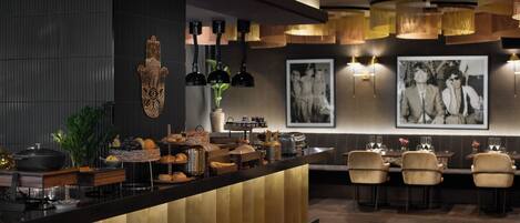 A modern bar area with a counter, seating, and decorative elements.