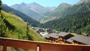 A mountain lodge with wooden cabins and a view of a valley and mountains. - 180m from shops, floor -1, view mountain, balcony, 29m², Méribel-Mottaret (Méribel - Les Allues)
