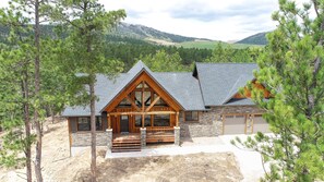 A lodge with a stone facade, wooden trim, and a prominent front porch.