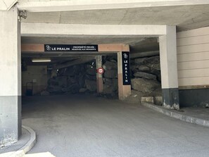 An underground parking garage with a sign indicating it is private property reserved for residents.