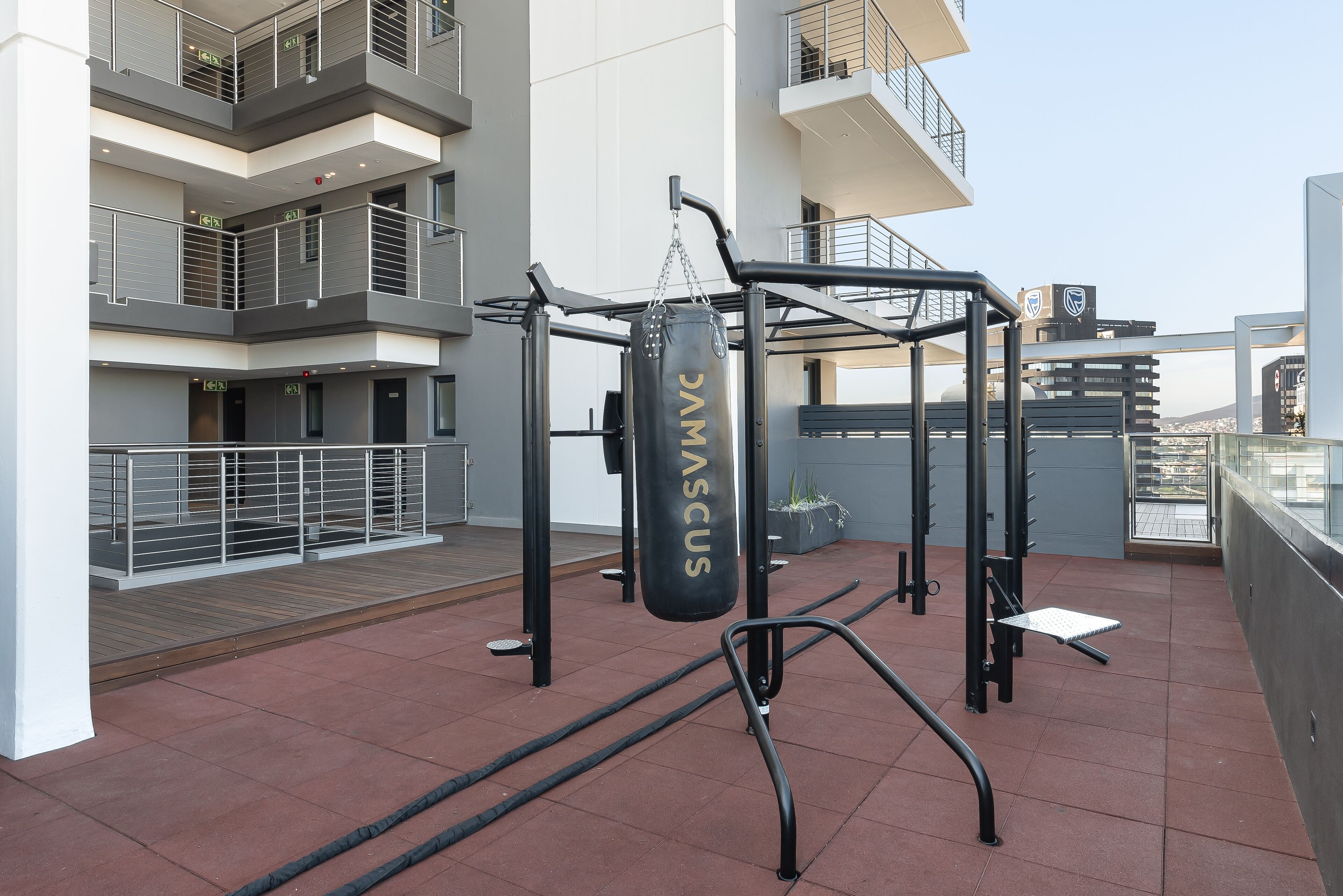A gym area with a punching bag labeled "DMC VASCUS" and exercise equipment.