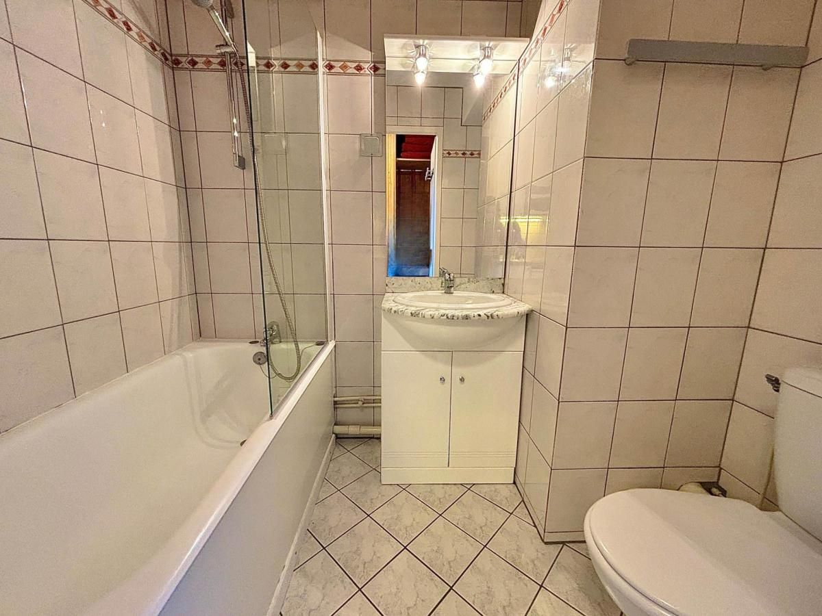 A bathroom with a bathtub, a sink, and a toilet.