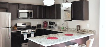 AT YOUR SERVICE! Downtown Aurora 1 Bedroom River Facing Gem