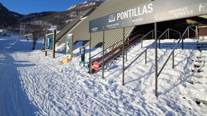 A ski resort entrance with signage for 'Pontillas' and 'Skipass Express'.