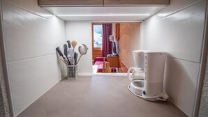 A compact kitchen with a coffee maker, utensils, and a view into a dining area. - 300m from resort center, 2nd floor, view ski slopes, balcony, tv, ski locker, 27m², Valmorel (Valmorel)