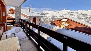 A balcony with a view of snow-covered mountains.