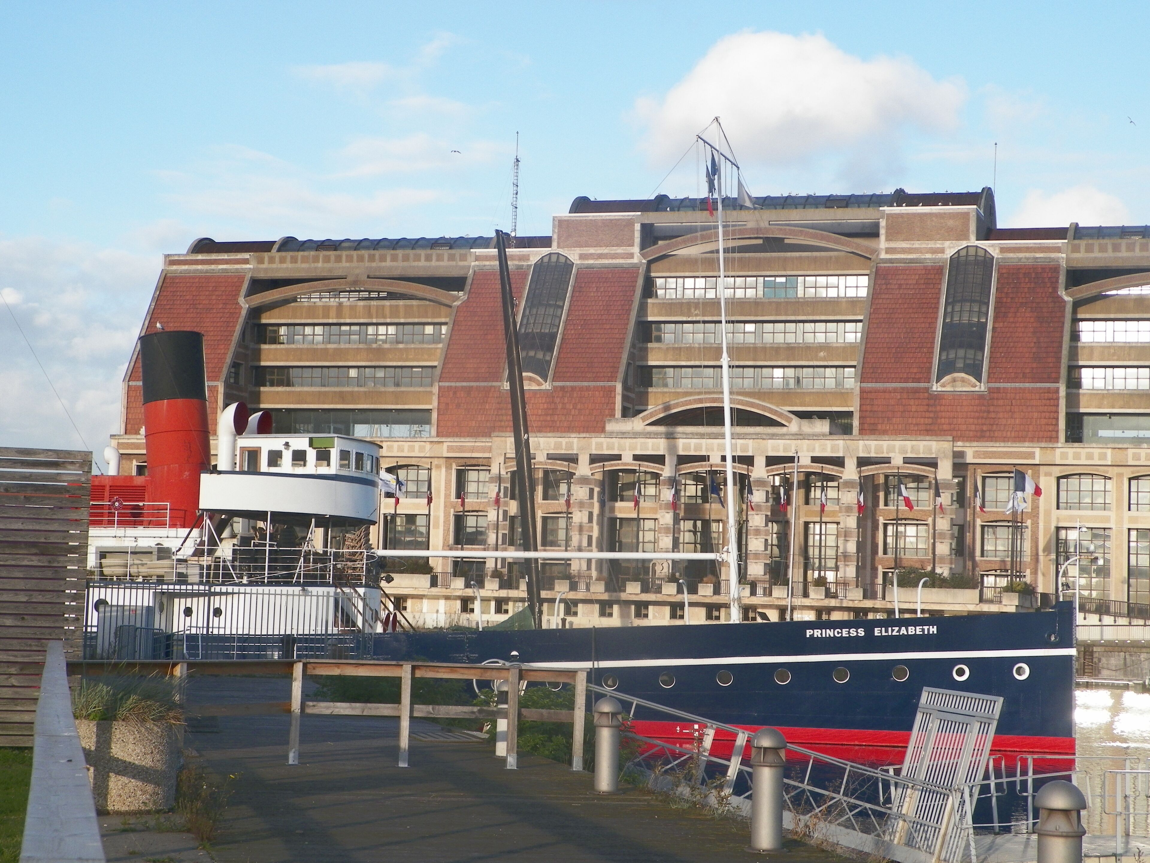 A large building with multiple windows and a red brick facade.