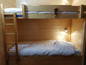 A bunk bed with a ladder on the left, a small shelf on the top bunk, and a single light fixture on the wall. - 200m from resort center, 10th floor, tv, 44m², Les Arcs (Les Arcs)