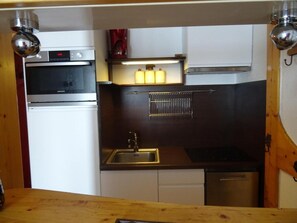 Enjoy cooking in this well-equipped kitchen with a refrigerator, oven, and dishwasher.
