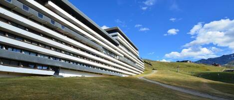 A modern building with horizontal lines and a clear sky.