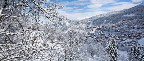 A snow-covered mountain landscape with a cluster of cabins.