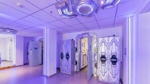 A hallway with modern doors and a ceiling with geometric light fixtures. - Binyue Hotel (East Building) (Hohhot)