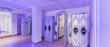 A hallway with modern doors and a ceiling with geometric light fixtures.