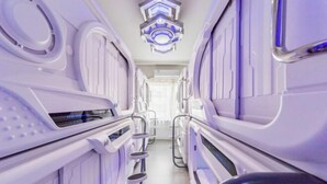 A futuristic, sterile corridor with metallic surfaces and a central walkway. - Binyue Hotel (East Building) (Hohhot)