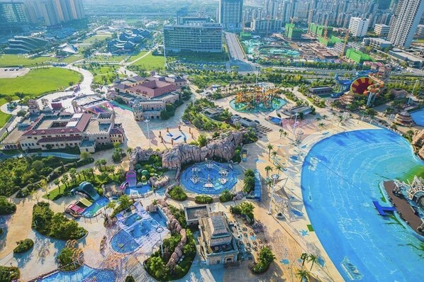 A large resort with multiple swimming pools, a beach area, and a variety of buildings.