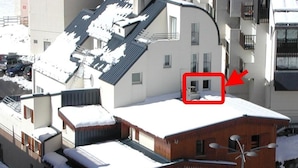 A building with a snow-covered roof, a sign for 'Le Chalet', and a 'Le SCHUSS' sign. - 150m from ski slopes, 3rd floor, view resort, fitness, swimming pool, sauna, tv, ski locker, 35m² (Eaux-Bonnes)