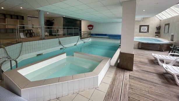 A swimming pool with a hot tub, lounge chairs, and a tiled floor. - 150m from ski slopes, 3rd floor, view ski slopes, fitness, swimming pool, sauna, tv, ski locker (Eaux-Bonnes)