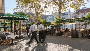 An outdoor café with tables and chairs, a green awning, and a sign for 'Paris Beauturg'. - Marais Rue de Turenne  and its very particular charming atmosphere.
 (Paris)