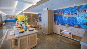 A modern kitchen with a marble countertop, wooden cabinets, and a blue-tiled backsplash. - Xiangtan Manqi Hotel (Xiangtan)
