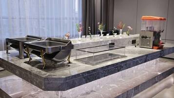 A modern bathroom with a marble countertop, two sinks, a large bathtub, and a shower area.