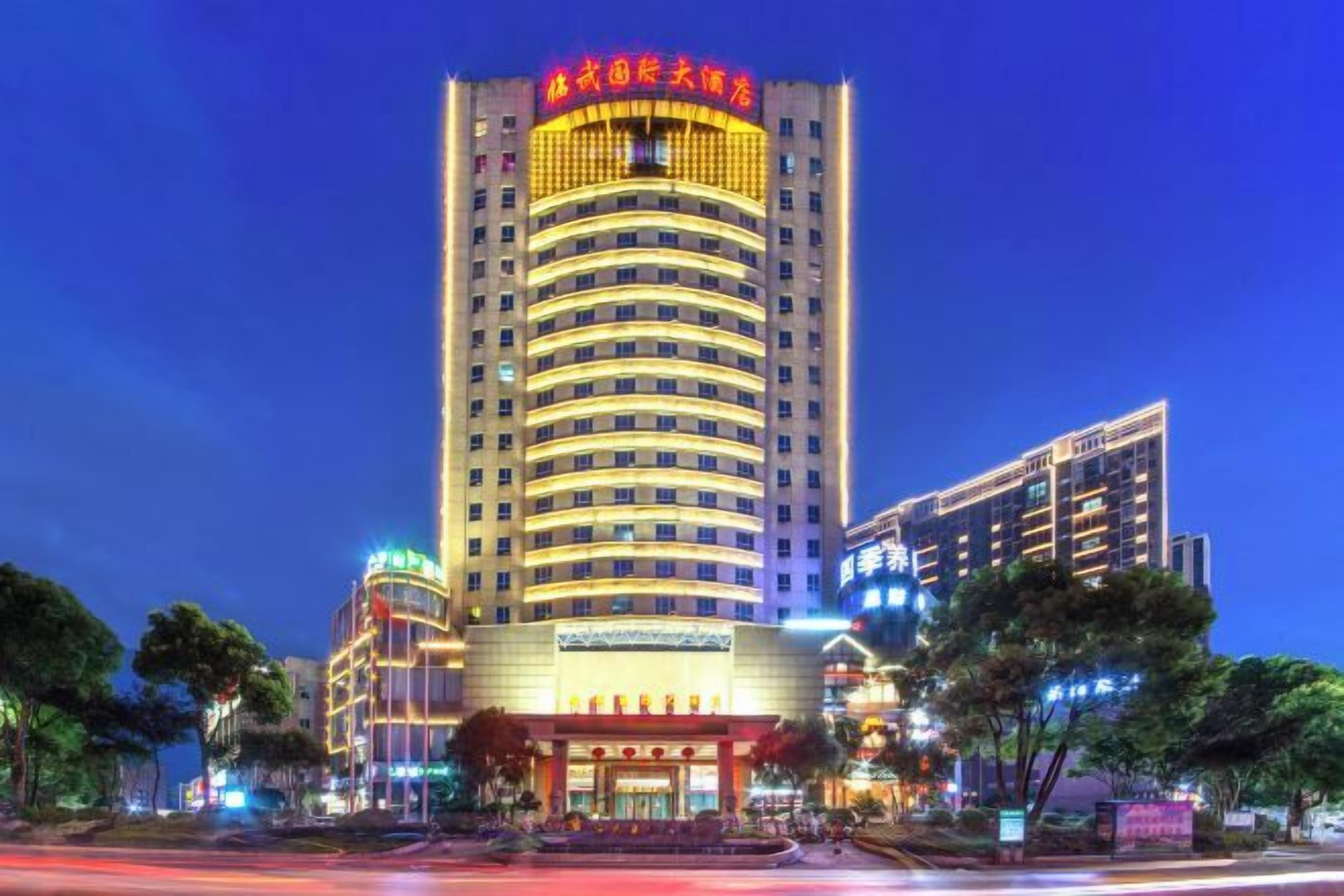 A multi-story hotel with a prominent entrance and signage.