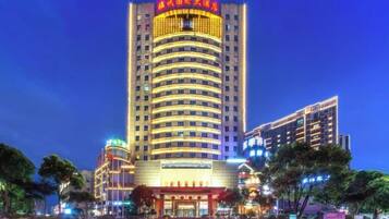 A multi-story hotel with a prominent entrance and signage.