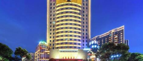 A multi-story hotel with a prominent entrance and signage.