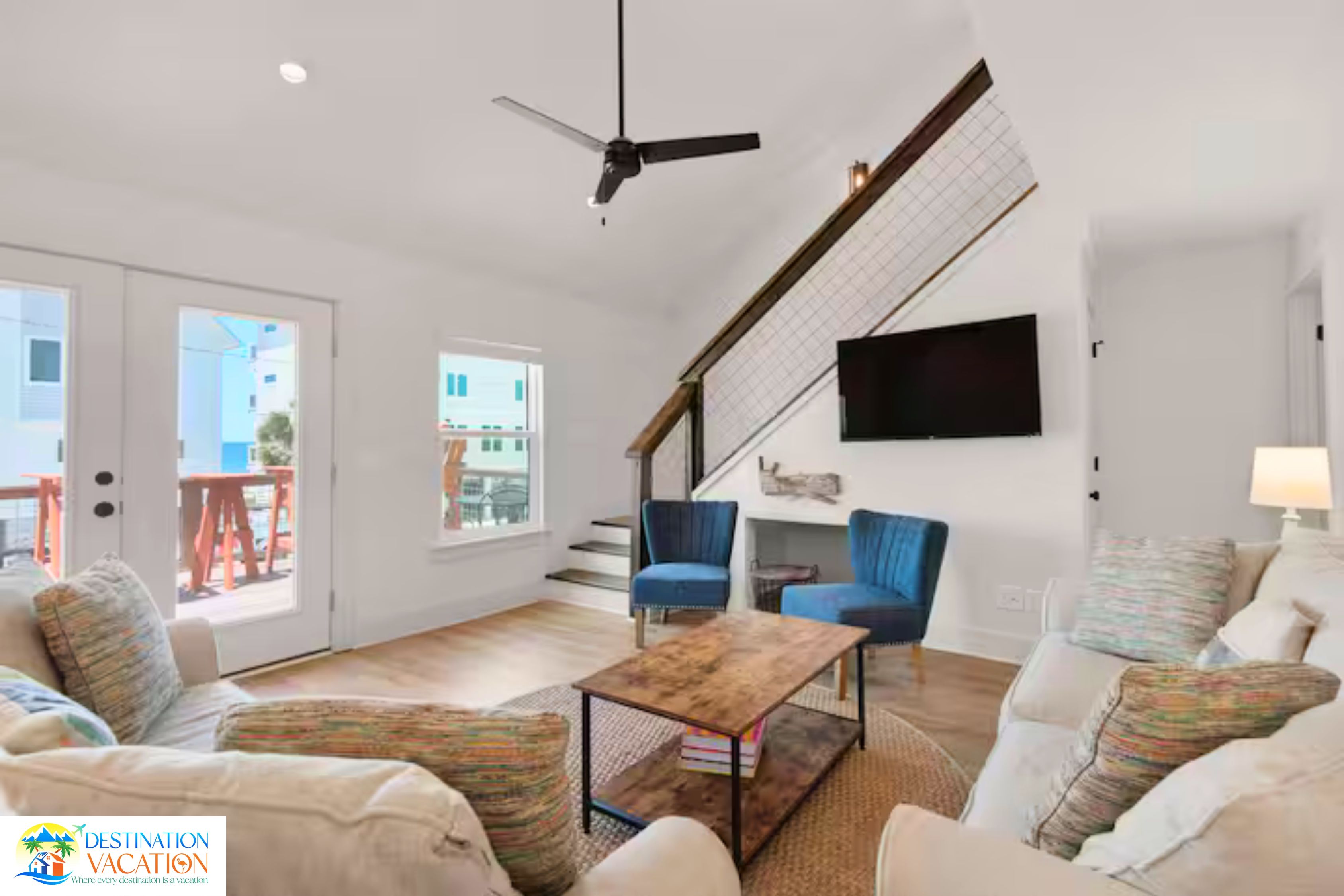 A modern living room with a sofa, a coffee table, and a TV mounted on the wall.