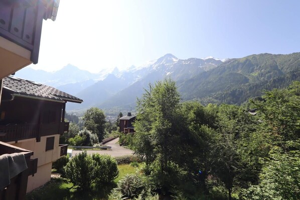 A mountain view with buildings and greenery.