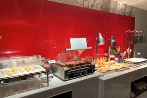 A buffet setup with a variety of food items, including a grill, a fruit display, and a beverage station. - Hao Fu Hua Hotel (Quanzhou)