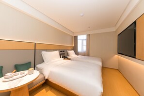 A hotel room with two beds, a TV, a bedside table, and a window. - Ji Hotel (Shanghai)