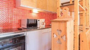 A kitchen with wooden cabinets, a microwave, a coffee maker, and a dishwasher.