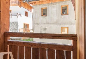 Enjoy a balcony with a view of the surrounding cityscape, featuring a comfortable seating area.