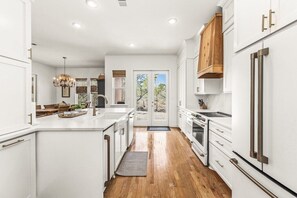 Enjoy cooking in this well-equipped kitchen with a large island, oven, and refrigerator.