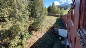 A train station with a red building, surrounded by trees and a grassy area. - 14th floor, view valley, terrace, tv, 54m², Les Arcs (Les Arcs)
