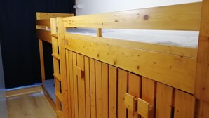 A wooden bed frame with a simple design and a mattress visible underneath. - 50m from shops, 3rd floor, view resort, balcony, tv, 33m², Les Arcs (Les Arcs)