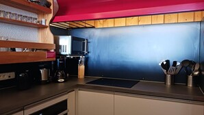 A kitchen with wooden shelves, a coffee machine, and a red ceiling. - 50m from ski slopes, 3rd floor, view ski slopes, balcony, tv, 65m², Les Arcs (Bourg-Saint-Maurice)
