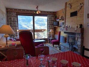 Relax in this inviting living room with a fireplace and stunning mountain views.