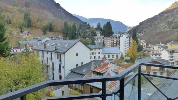 A residential area with houses and a mountain backdrop.