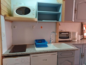 A compact kitchen with a microwave, toaster, and coffee maker.