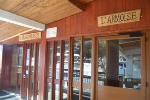 Welcome to Le Grand d'Arbois, where a traditional facade and large glass doors invite you in.
