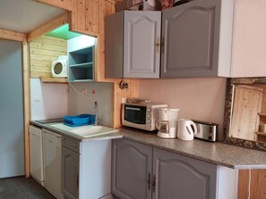 A compact kitchen with a microwave, toaster, and coffee maker.