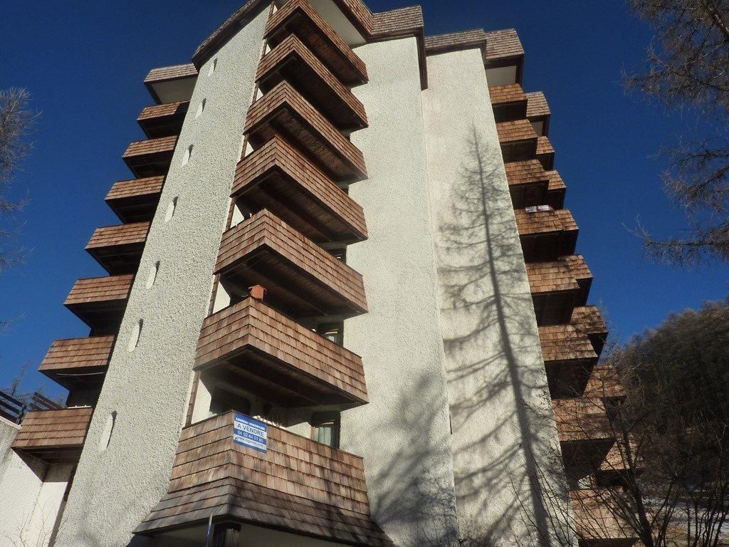 A multi-story building with balconies.