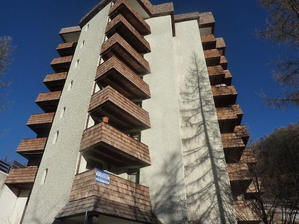 A multi-story building with balconies.