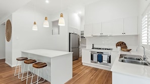 Stovetop, dishwasher, coffee/tea maker, dining tables