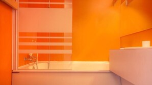 Un baño con bañera, inodoro y lavamanos.