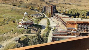 A rural landscape with a large building complex, including a school and residential structures.