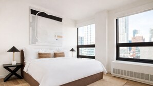 A modern bedroom with a large bed, two nightstands, a city view, and a large abstract painting on the wall. - Court Square Hotel Long Island City New York , Belvilla District 6 Formerly Sonder (Long Island City)